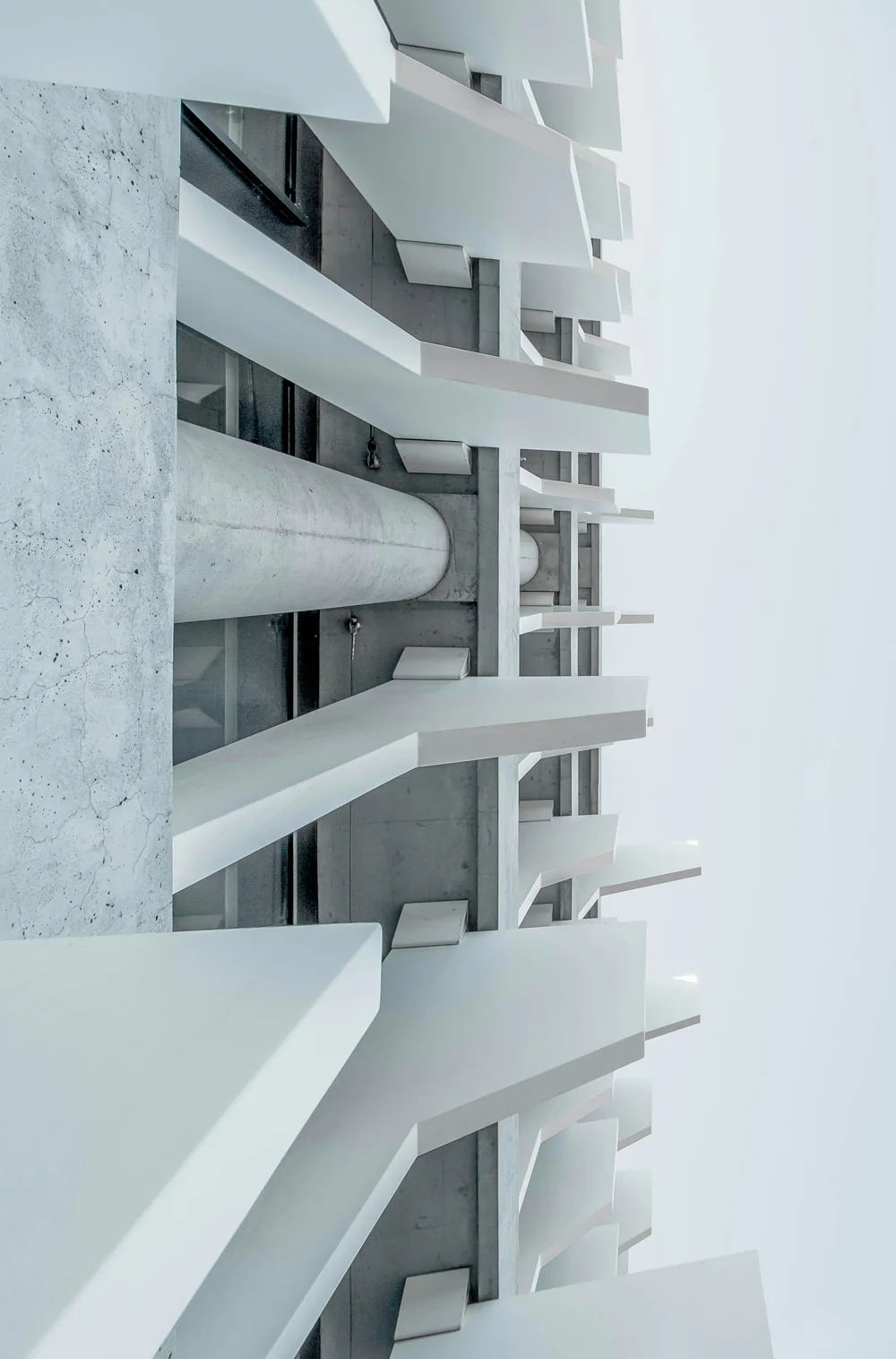 Detalle de estructura y planos de hormigón blanco en una fachada de Madrid.